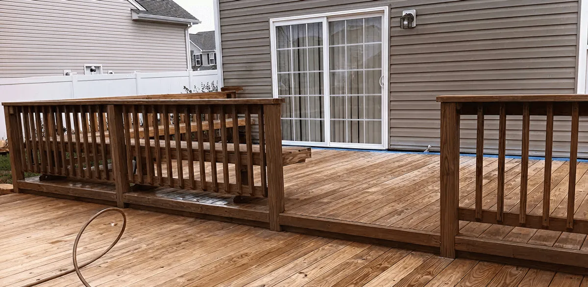 Deck sealing service protecting a backyard wood deck and railings in Omaha, NE