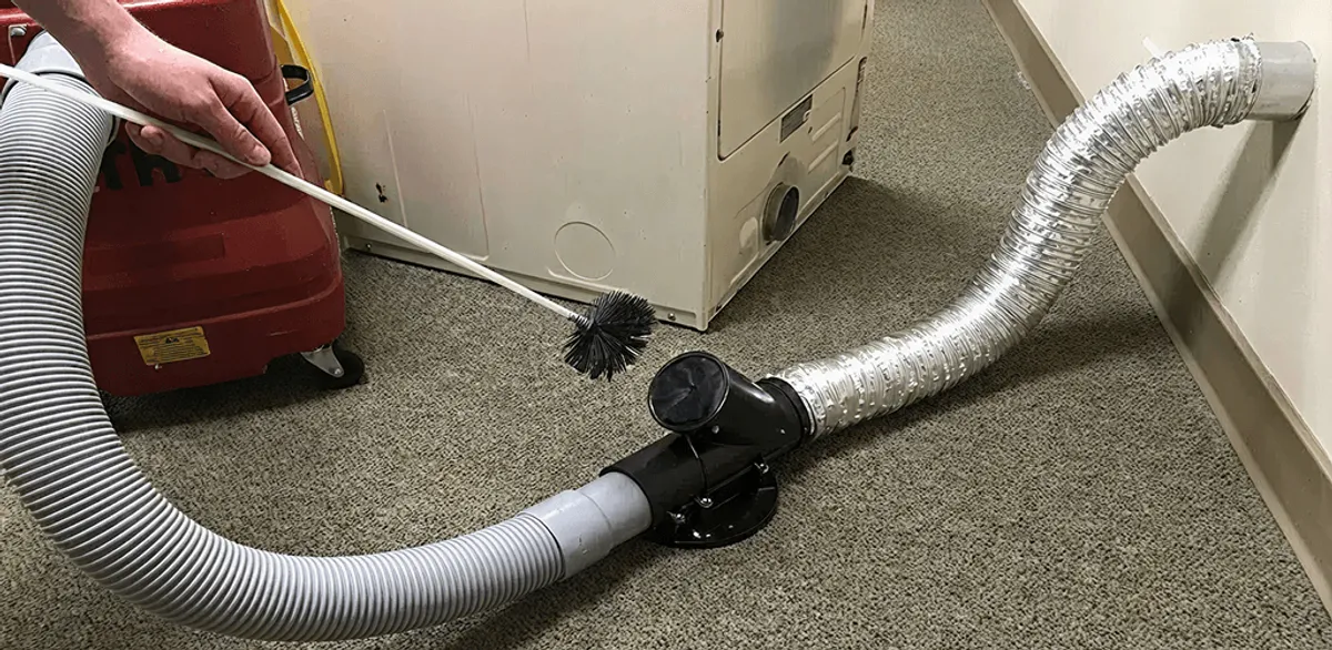 Dryer vent cleaning service removing lint from a dryer duct connection in Omaha, NE