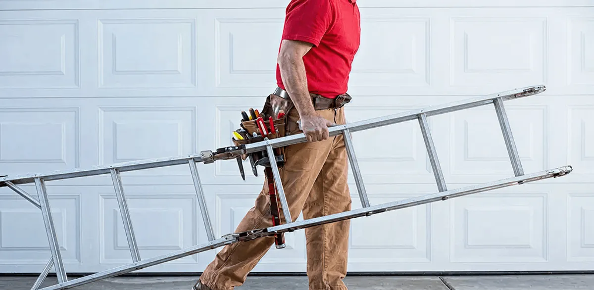 Garage door repair technician arriving with tools and ladder in Omaha, NE