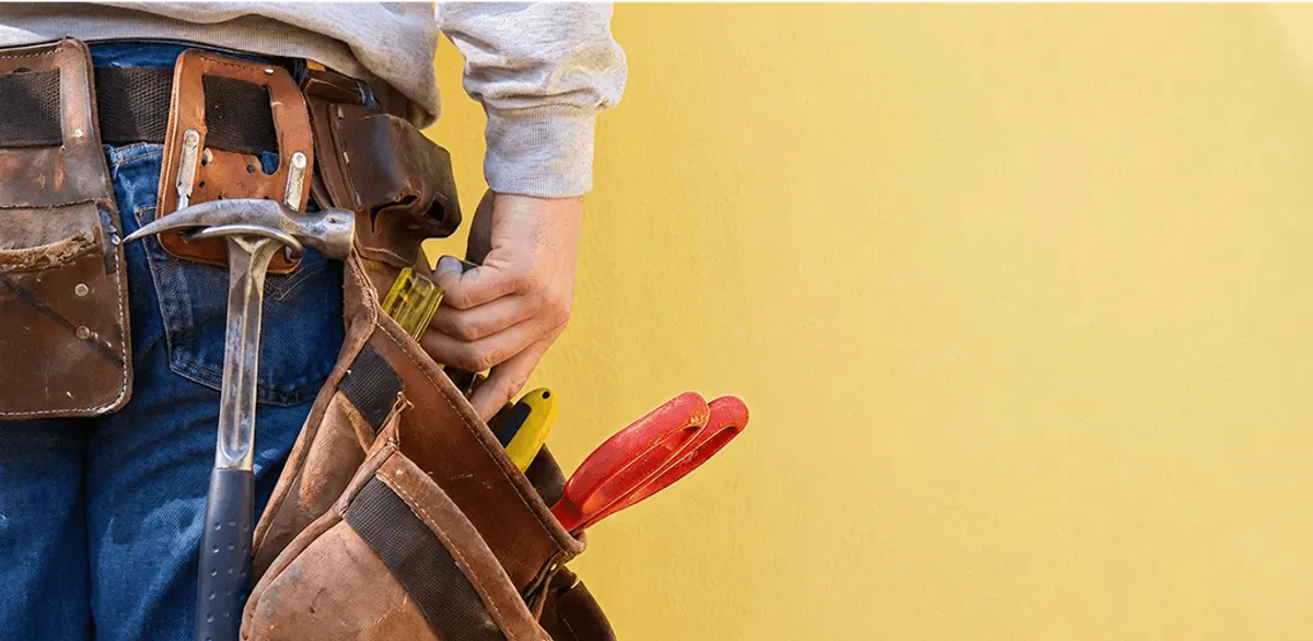 Handyman with tool belt ready for home repairs and maintenance in Omaha, NE