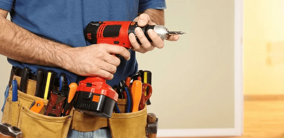 Handyman holding a power drill for home repairs and installations in Omaha, NE