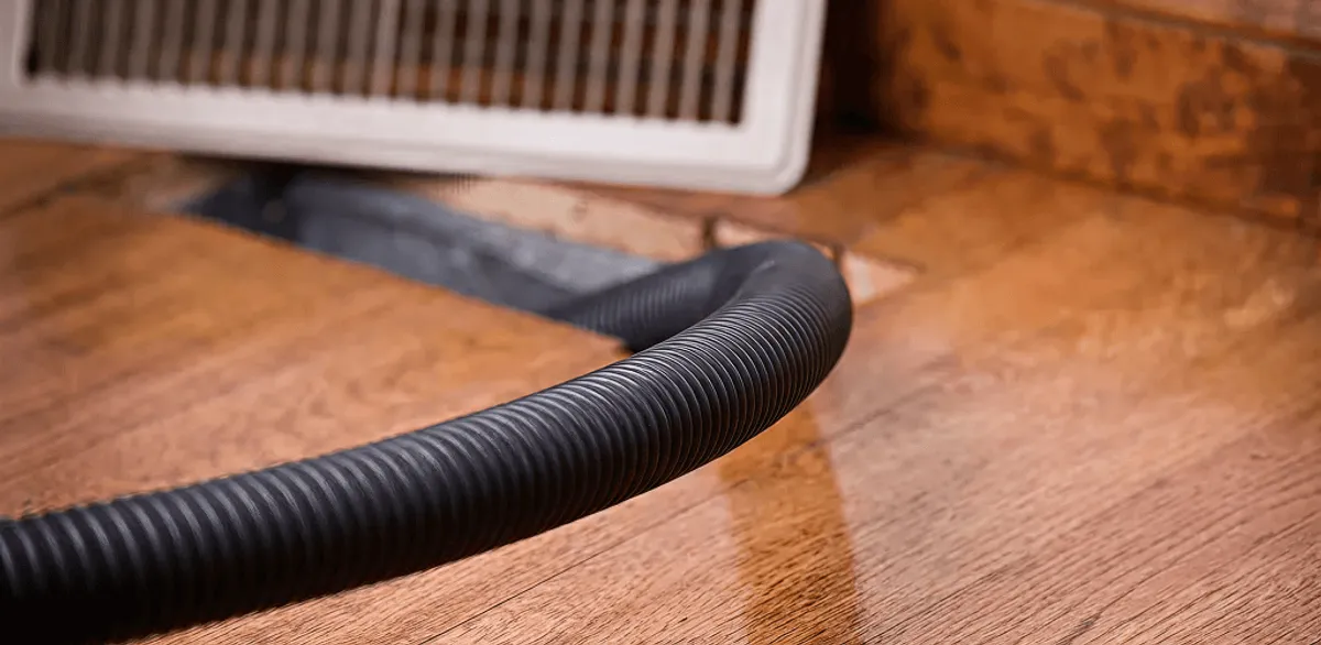 Air duct cleaning hose inserted into a floor vent for ductwork cleaning in Omaha, NE