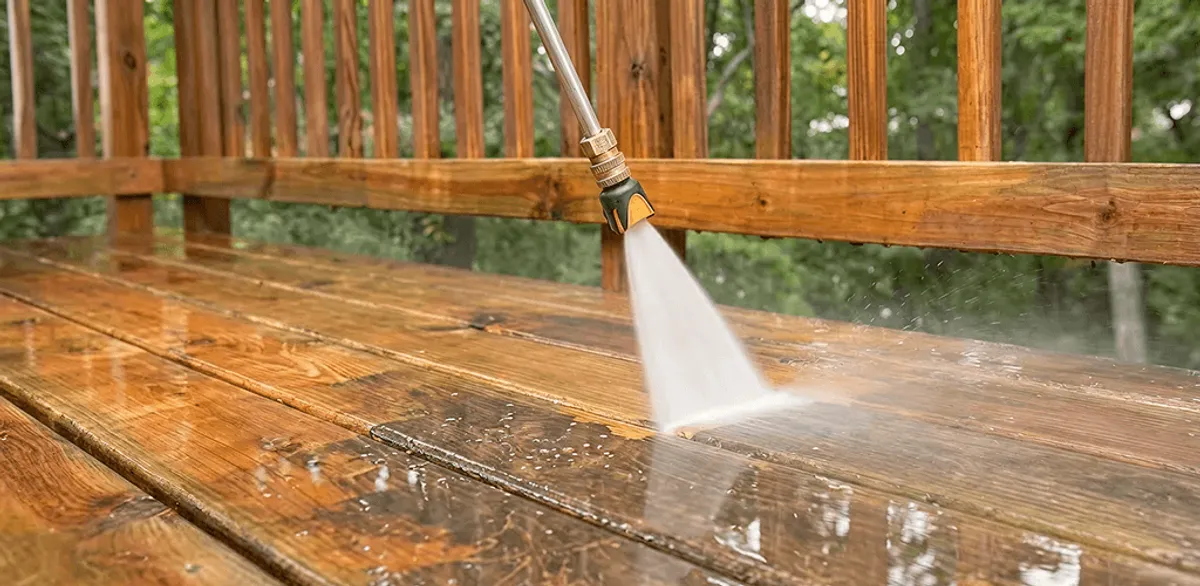 Pressure washing a wood deck to remove dirt and buildup in Omaha, NE