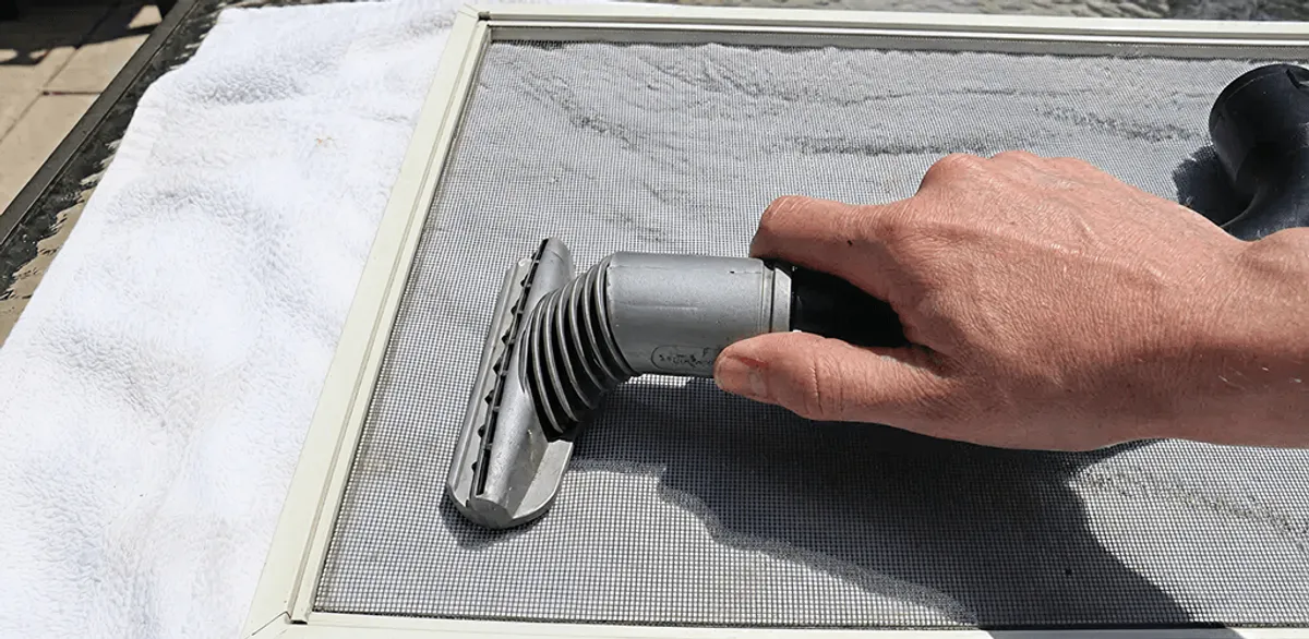 Window screen repair cleaning and fixing a damaged screen mesh in Omaha, NE